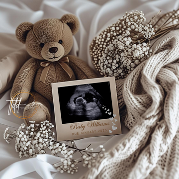 Brown teddy bear with an ultrasound photo and baby name on a soft fabric background