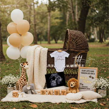 Baby reveal setup with balloons, crib, baby clothes, and toys outdoors.