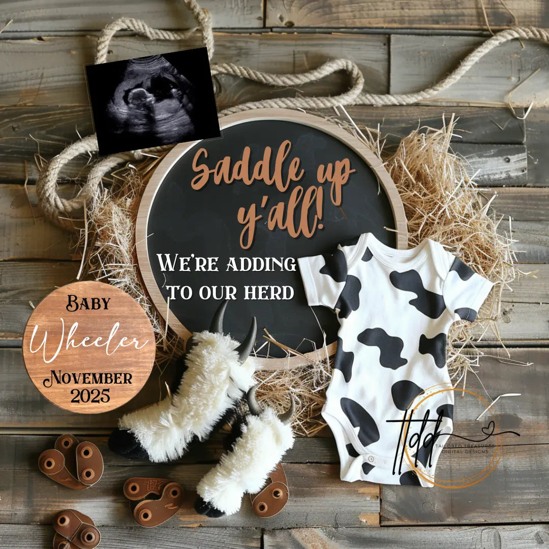 Baby announcement sign with cow print onesie and baby booties on a rustic wooden background